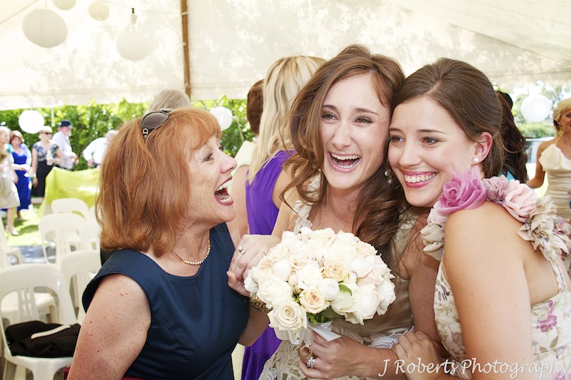 Bride laughing with bridesmaid and friend after marriage ceremony - wedding photography sydney